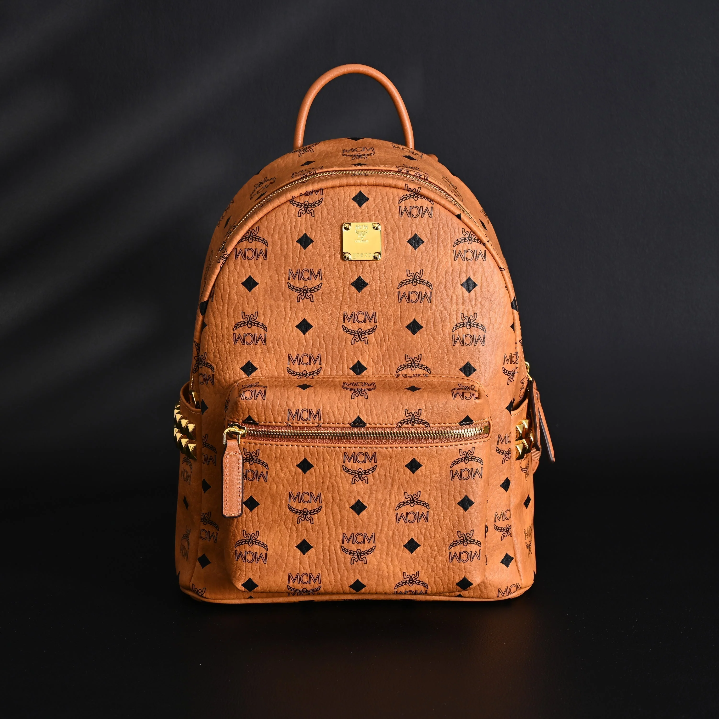 MCM Stark Visetos Medium Backpack – Cognac Monogram with Gold-Tone Studs