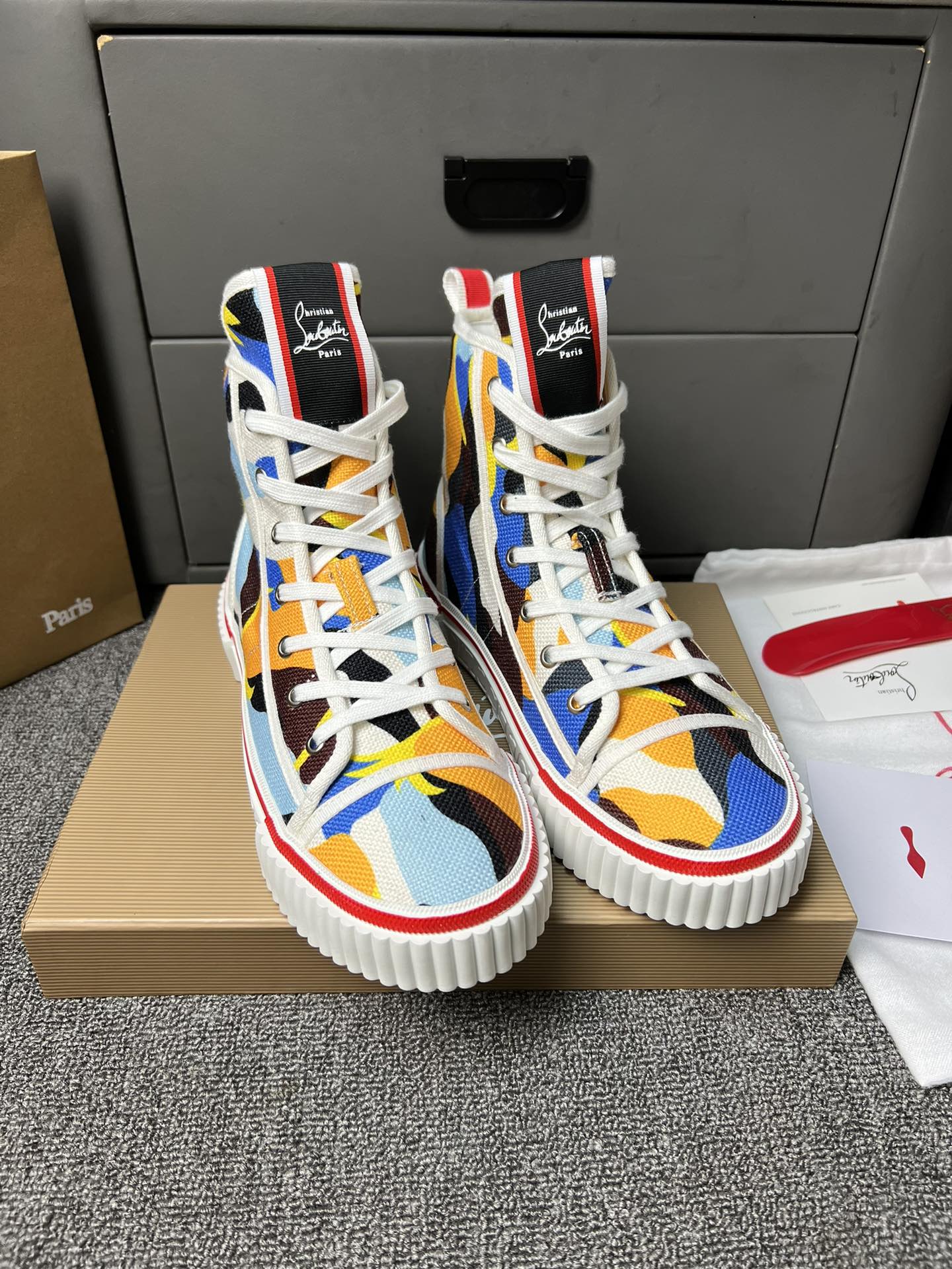 Loubouti'* latest red-soled canvas shoes