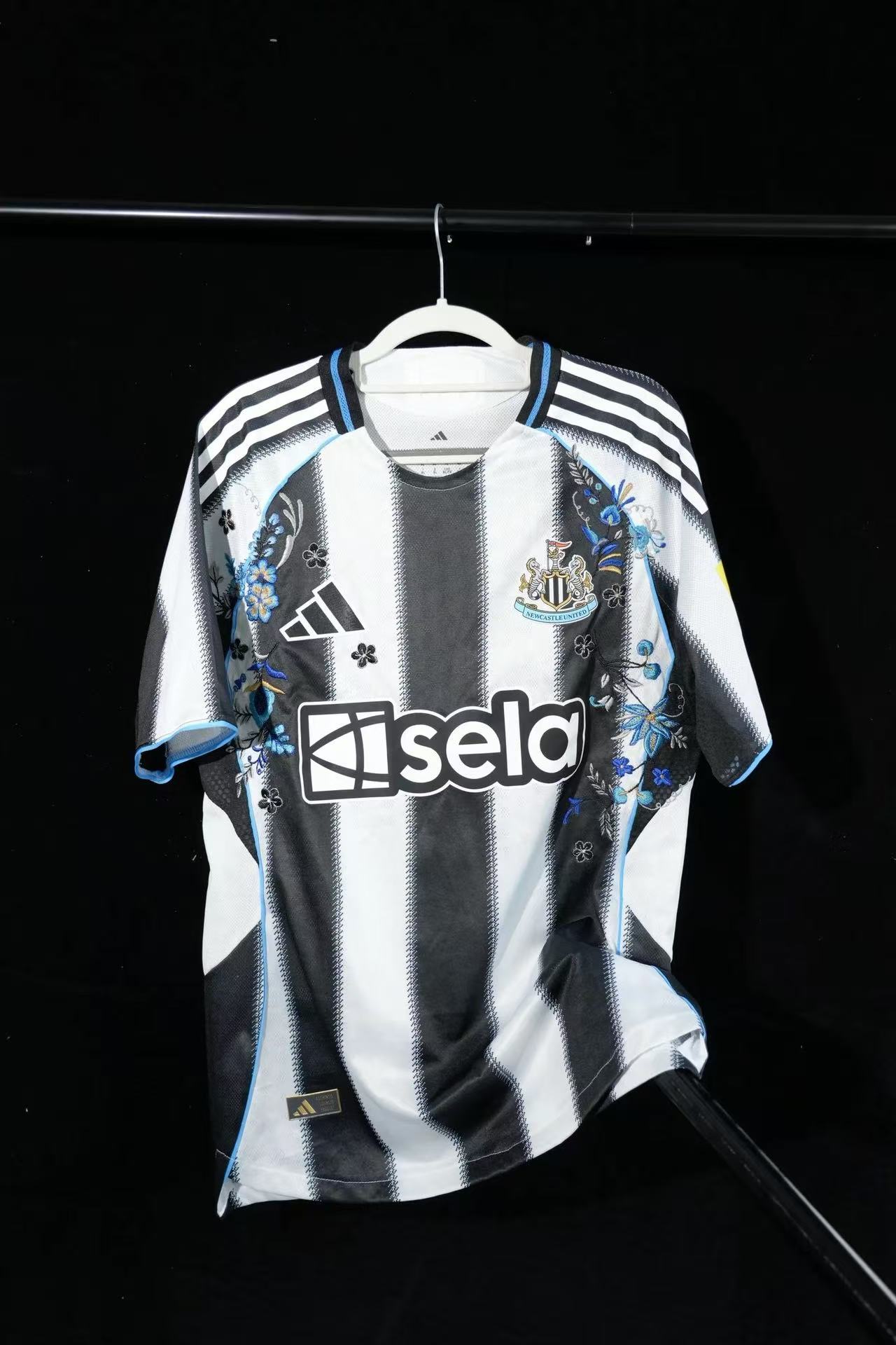 Newcastle United 2023/24 Home Special Edition Jersey – Black & White Stripes with Blue Floral Embroidery