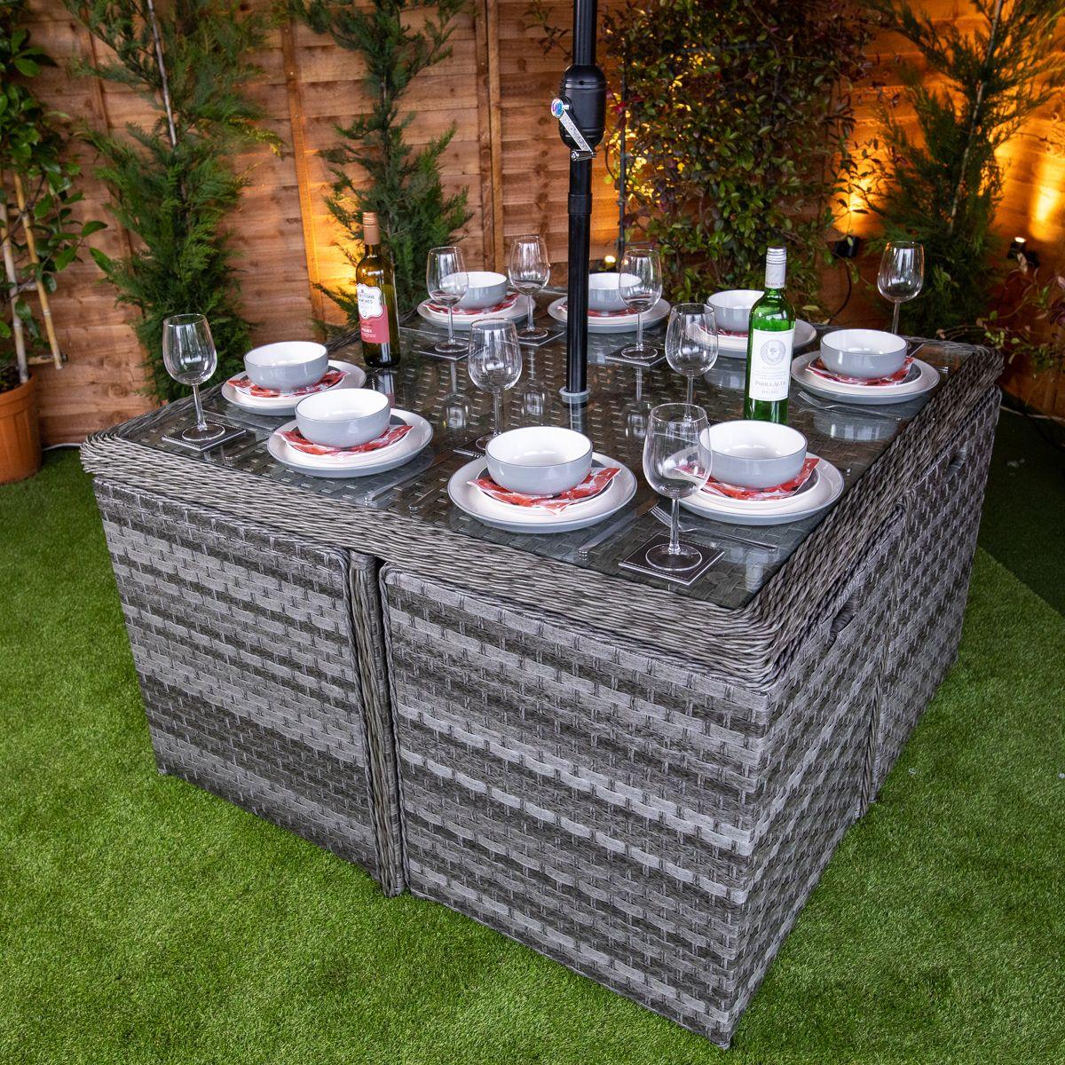 Flat pack 4 seat cube rattan outdoor sofa with 4 footrests.