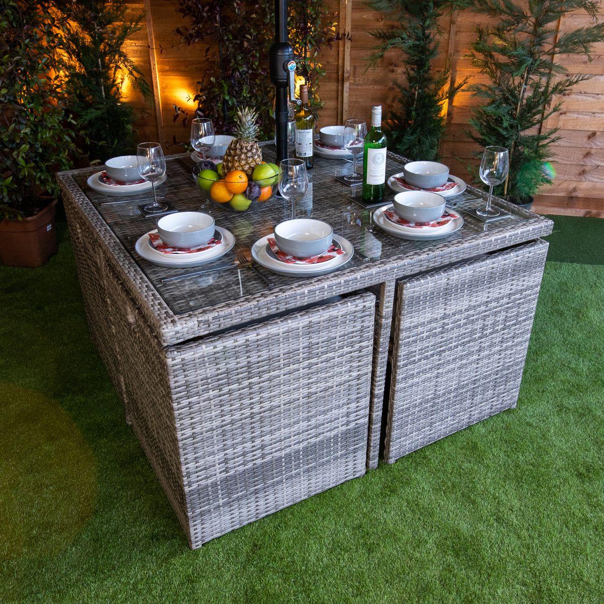 Flat pack 4 seat cube rattan outdoor sofa with 4 footrests.